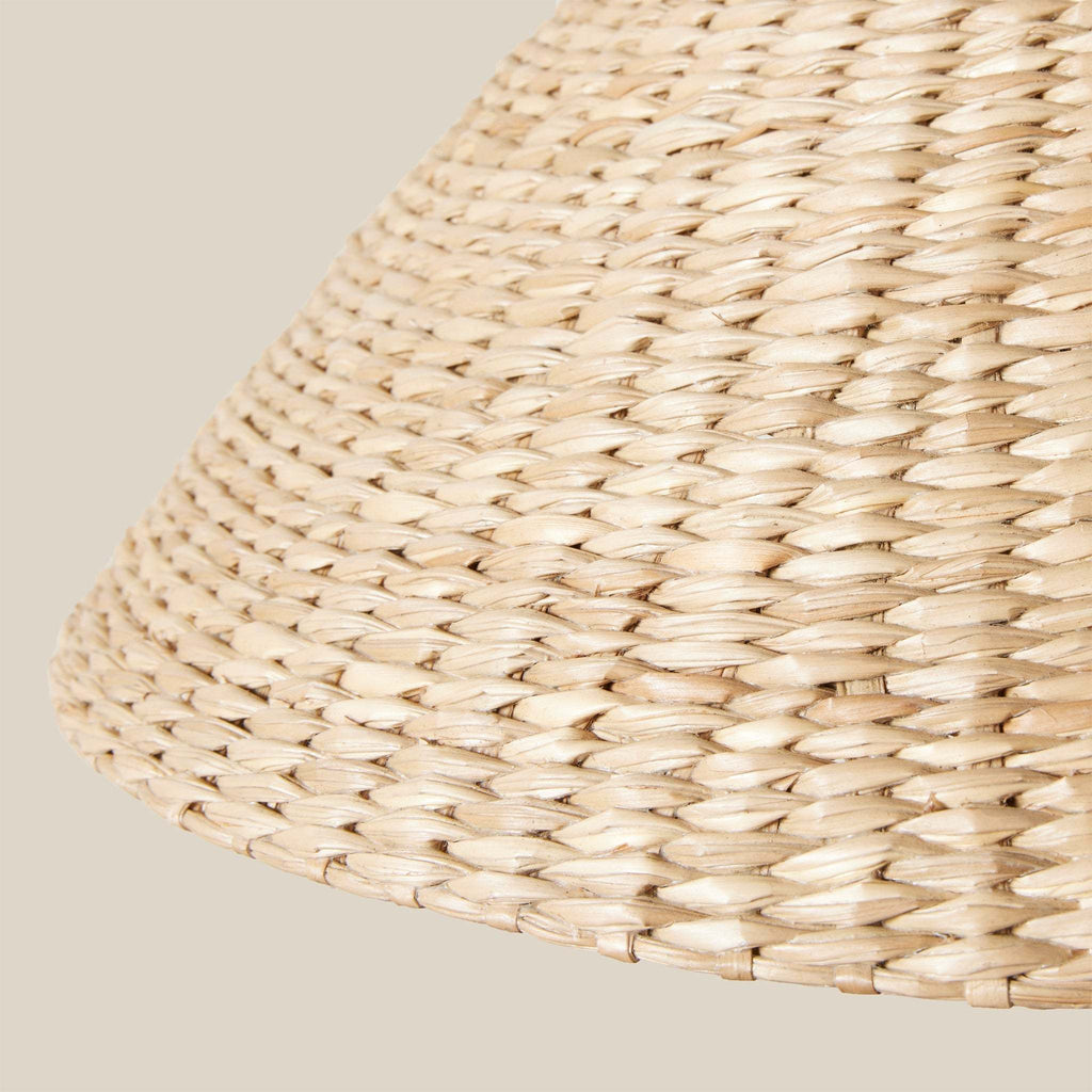 Close-up of a woven Bainbridge linear pendant shade on a beige background