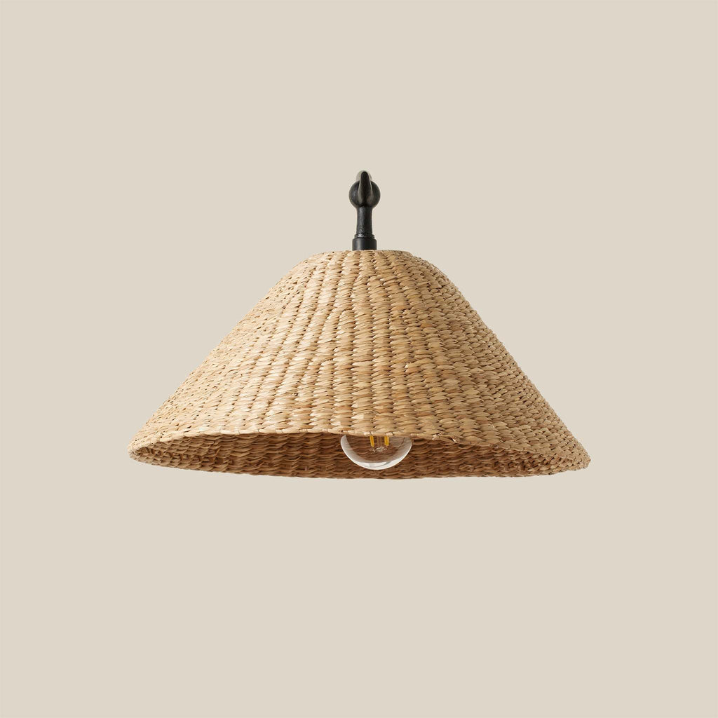 Woven seagrass Bainbridge oversized sconce with woven natural material on a beige background.