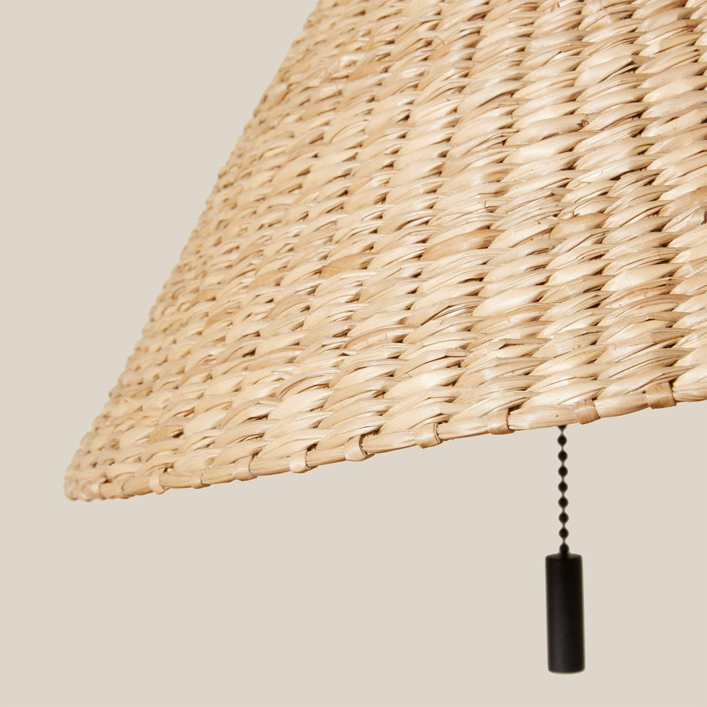 Woven lampshade from Bainbridge table lamp with a pull chain on a beige background
