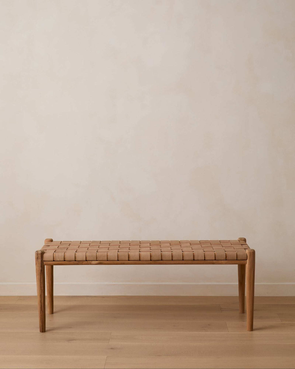 Beige woven leather bench with teak frame and turned legs, handcrafted in Bali, second quality with natural leather and wood variations