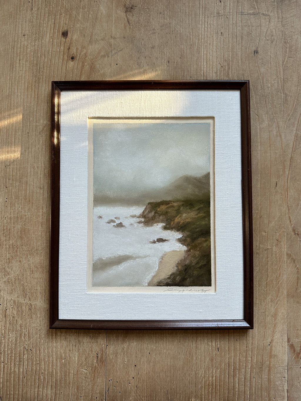 Pastel painting of rugged California coast titled Cliffside Haze by Lina Gordievsky, showcasing tranquil cliffs with soft, diffused colors.