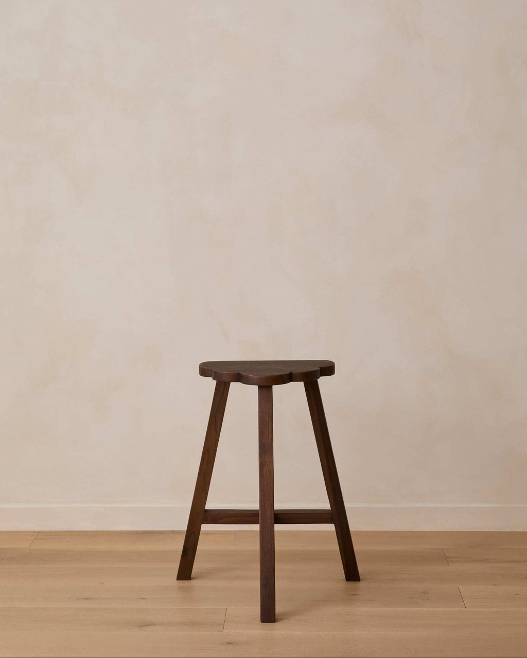 Cloud Counter Stool handcrafted from rich walnut wood with a cloud-shaped seat and sculptural design for modern kitchens