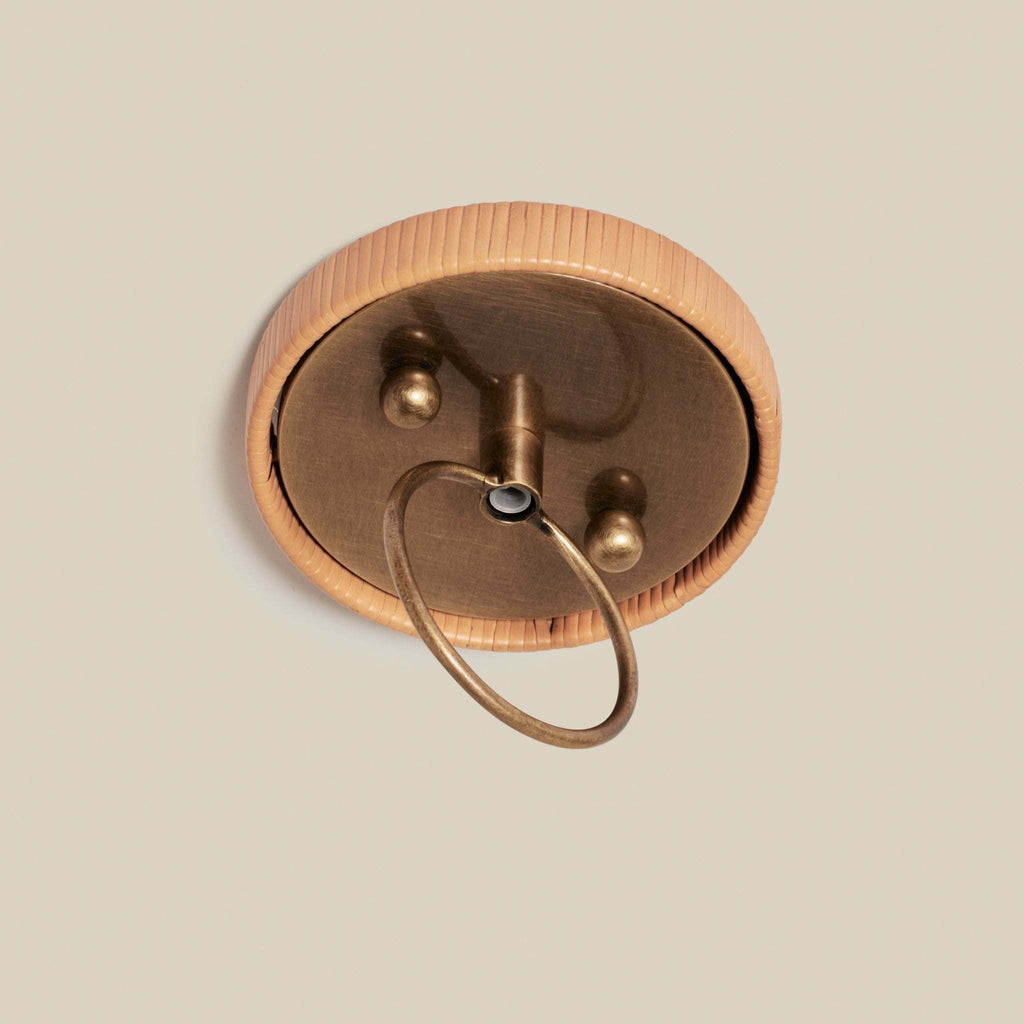 Bronze ceiling light fixture on a beige background