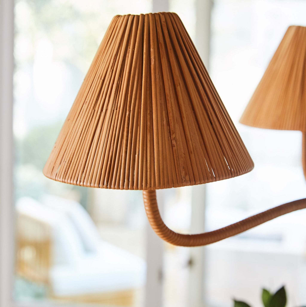 Brown pleated lampshade of a Delphine Chandelier on a blurred indoor background