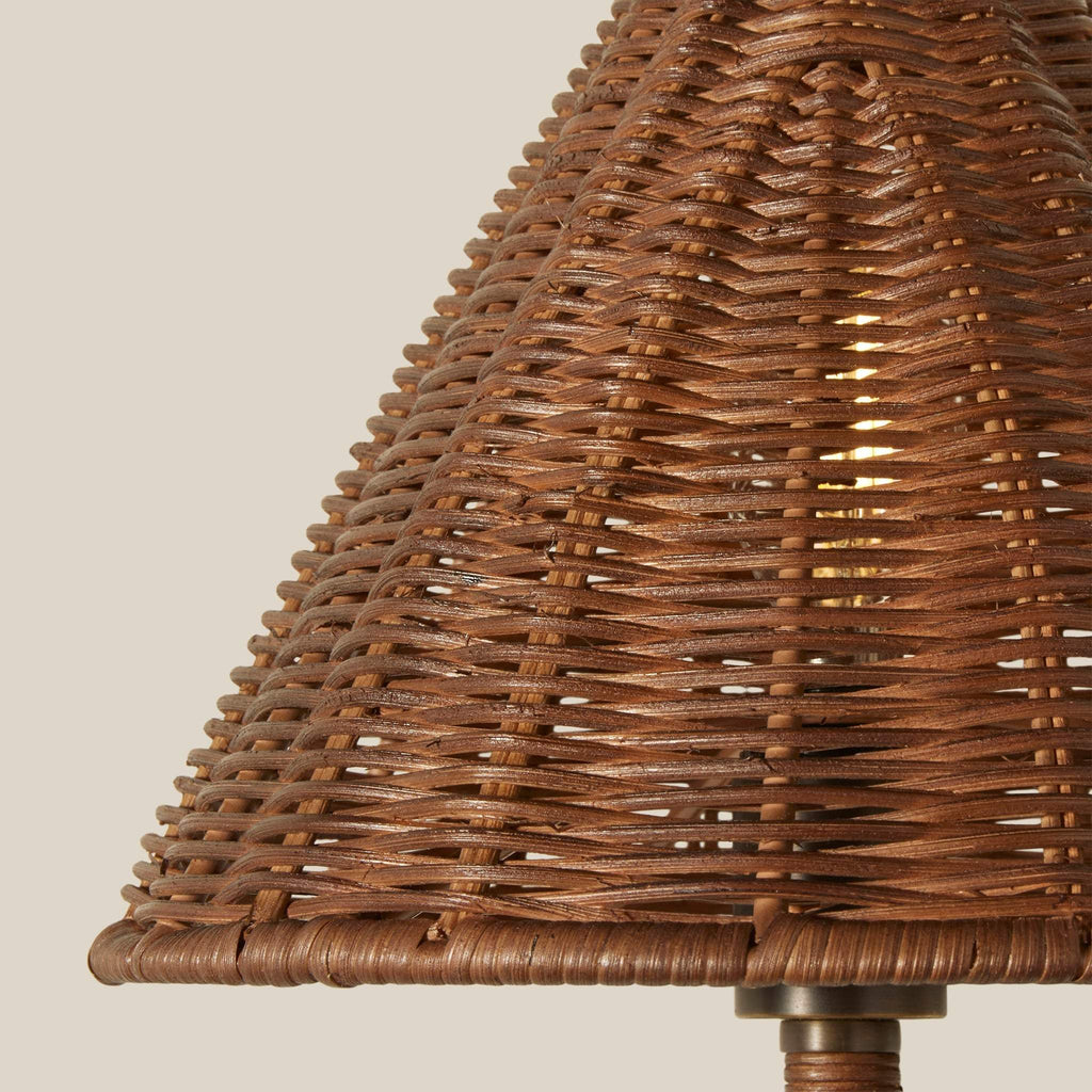 Close-up of woven wicker delphine lampshade with a textured basketweave pattern, set against a solid light beige background.
