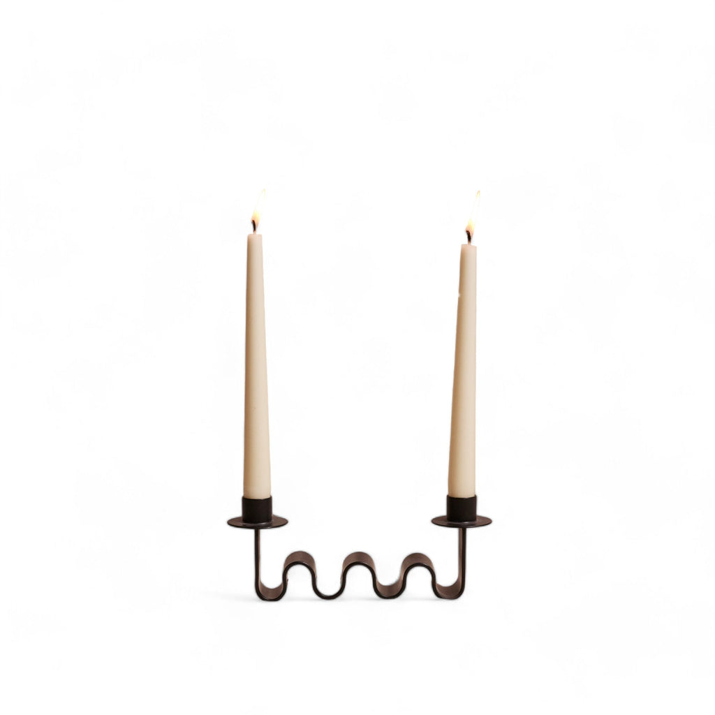 Blackened metal Ribbon Candle Holder with wave-like form holding two taper candles