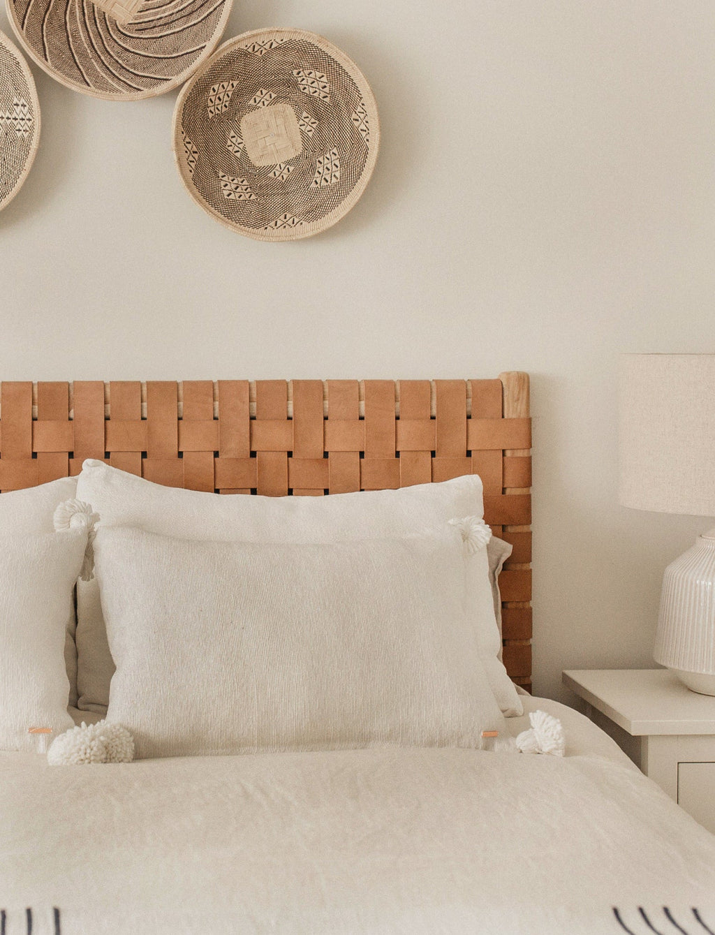 Woven leather strap headboard with beige leather and hand-carved teak frame in natural matte finish