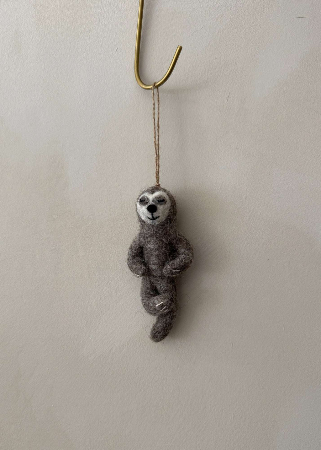 Hand-stitched felt yoga sloth ornament in a calming yoga pose, soft wool needle-felted design