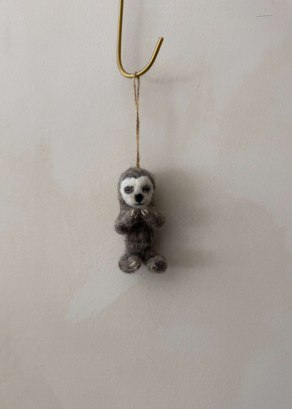 Hand-stitched felt yoga sloth ornament in a yoga pose, soft wool needle-felted decoration symbolizing calm and balance