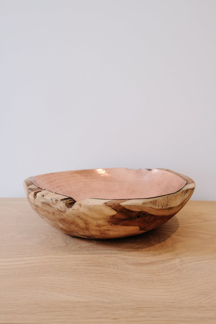 Front view of one Hammered Copper and Teak Bowl in Large with a white background. Featuring hand carved teak root in a natural matte finish lined with a hammered copper interior finish. - Saffron and Poe.