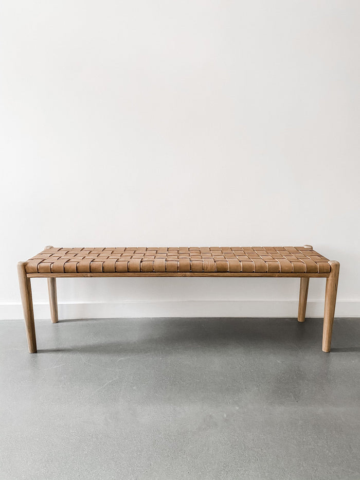 Front view of 60" woven leather strap bench in beige against white background. Handcrafted in Bali. Teak wood and leather straps. - Saffron and Poe