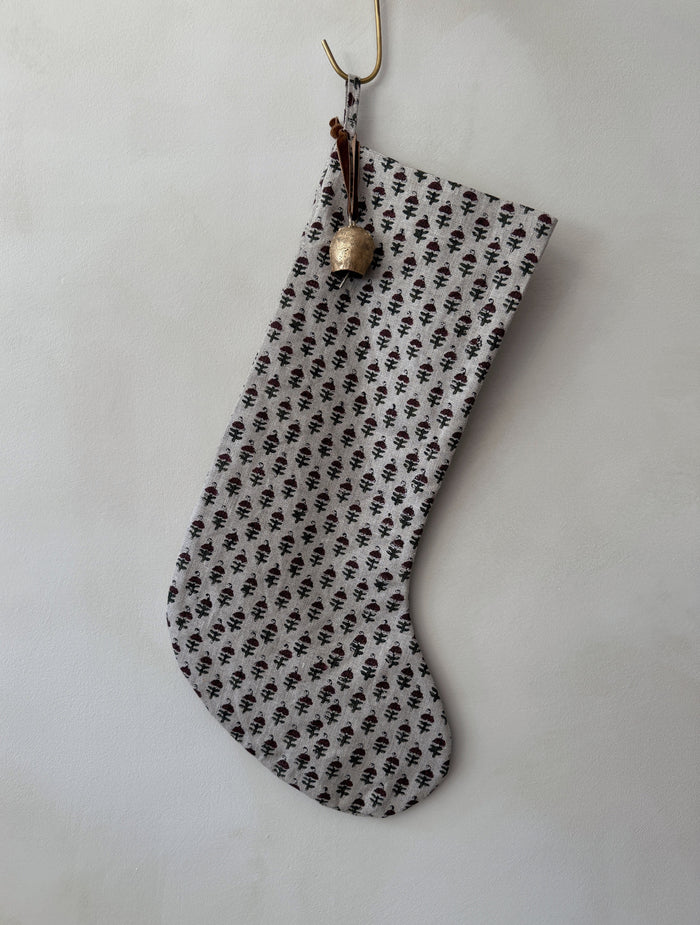 Indian Block Print stocking with floral pattern and bell on a white background - Saffron + Poe