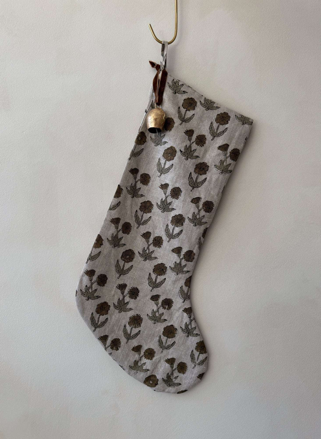 Indian Block Print Christmas Stocking hand block printed on 100% linen with vintage bell and cinnamon velvet ribbon hanging on mantel