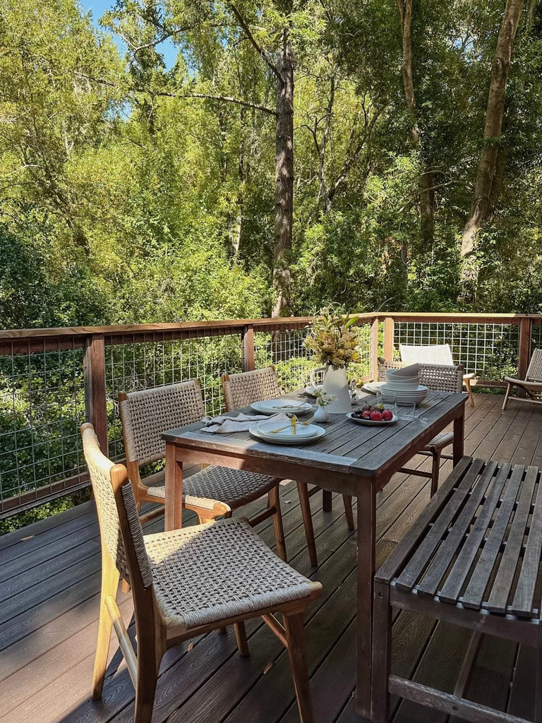 Woven Faux Rattan Marin Dining Chair styled on an outdoor deck. - Saffron and Poe