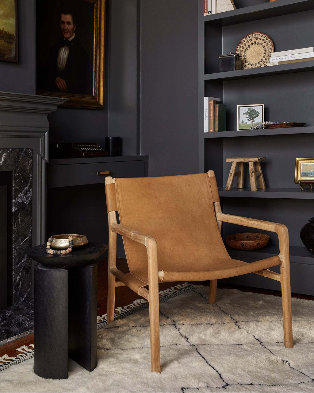 Modern beige leather sling lounge chair with carved teak frame handcrafted in Bali