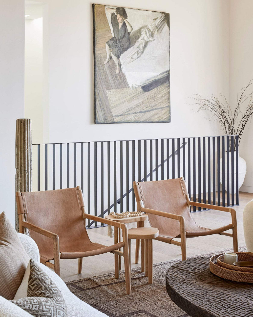 Modern leather sling lounge chair with teak frame and beige leather upholstery