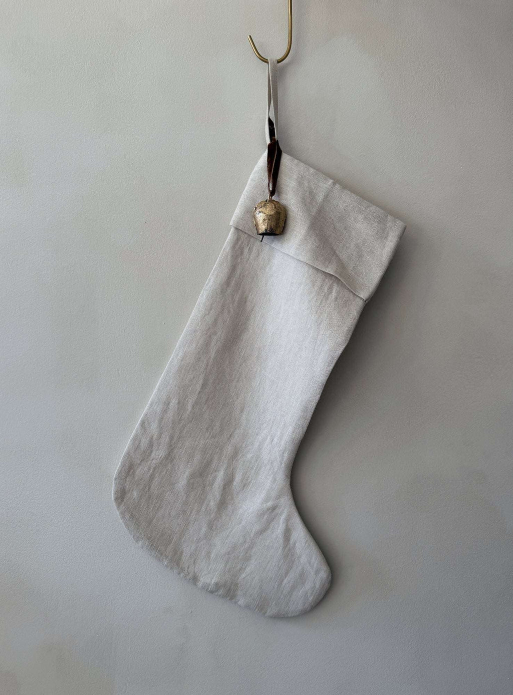 Natural linen stocking with antique bell and cinnamon ribbon, handmade double-lined oatmeal linen Christmas decoration