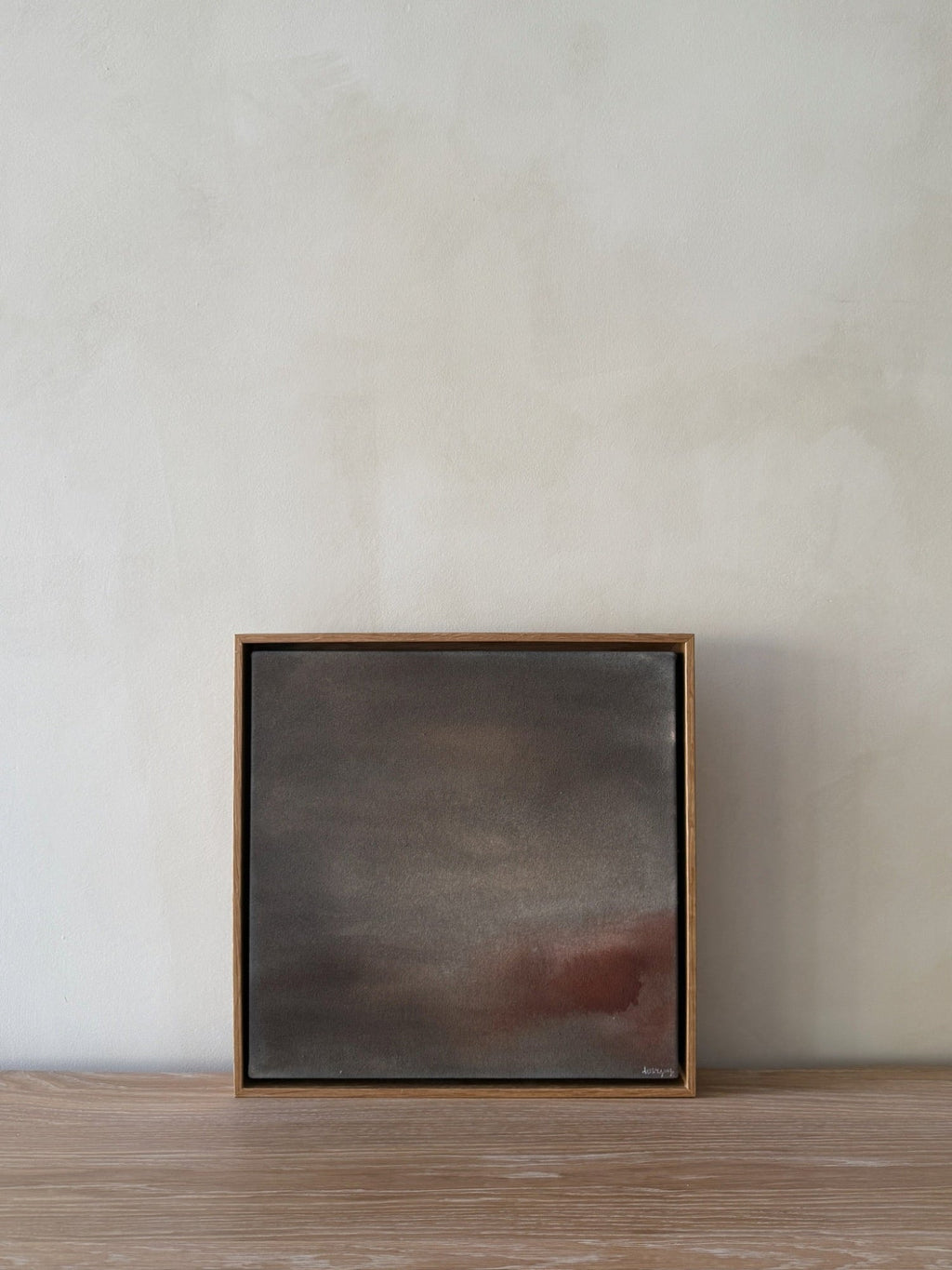 Abstract painting Untouched II with soft charcoal, taupe, and rust gradients on raw canvas in natural wood frame