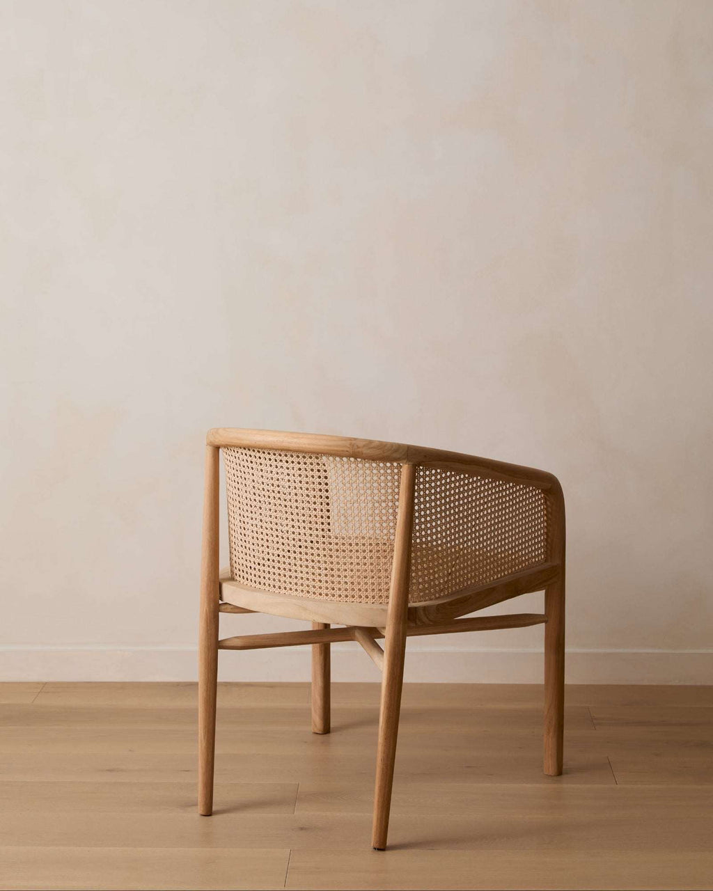 Olivia Rattan Accent Chair handcrafted from teak with open-weave rattan design in a light, stylish silhouette