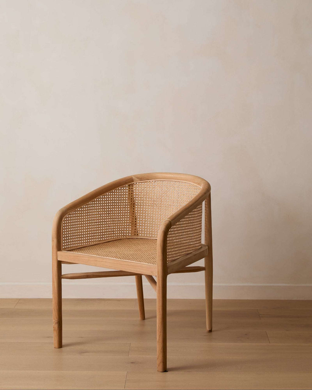 Olivia Rattan Accent Chair handcrafted from teak with woven rattan, featuring an open-weave design and sculptural frame