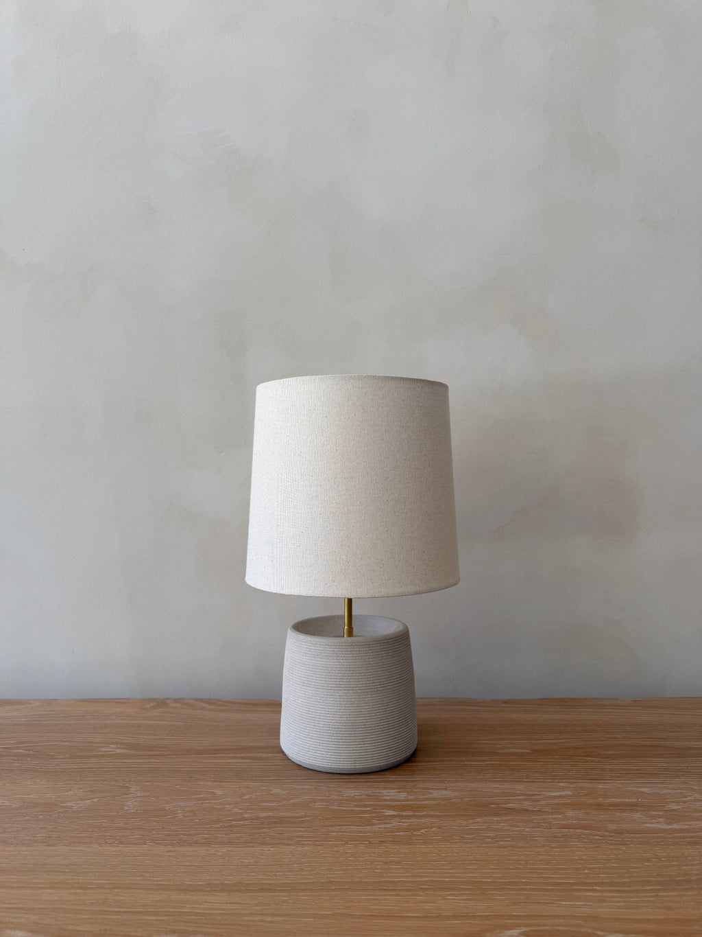 Ostuni Ceramic Table Lamp ivory hand-thrown ceramic base ribbed texture antique brass stem oatmeal linen shade with dimmer switch