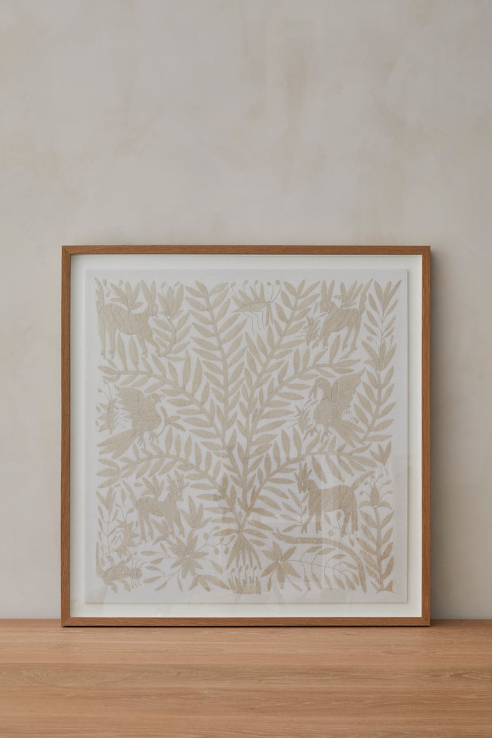 Otomi Textile Ivory Hand Embroidered Framed Art on a natural beige lime-wash background.