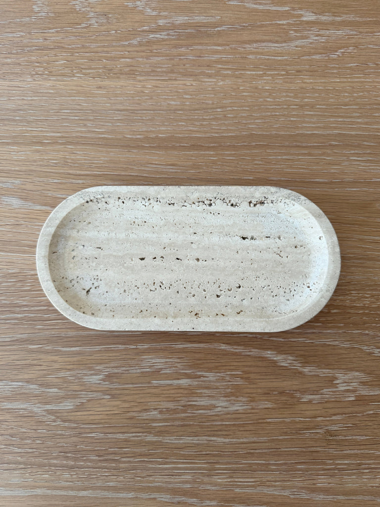 Oval-shaped stone tray on a wooden surface