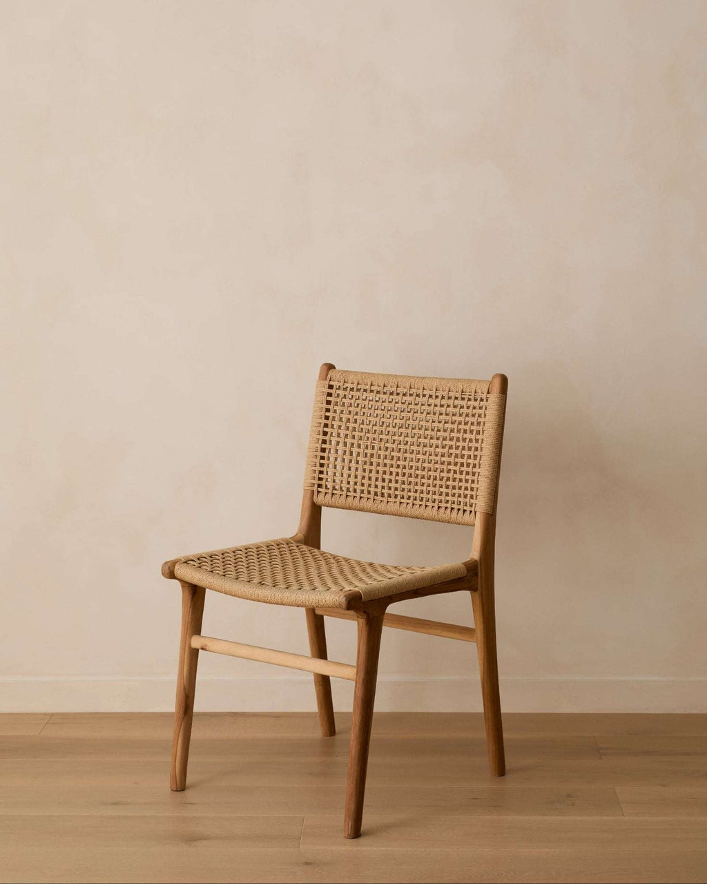 Handwoven paper cord dining chair with teak wood frame showcasing natural textures and craftsmanship