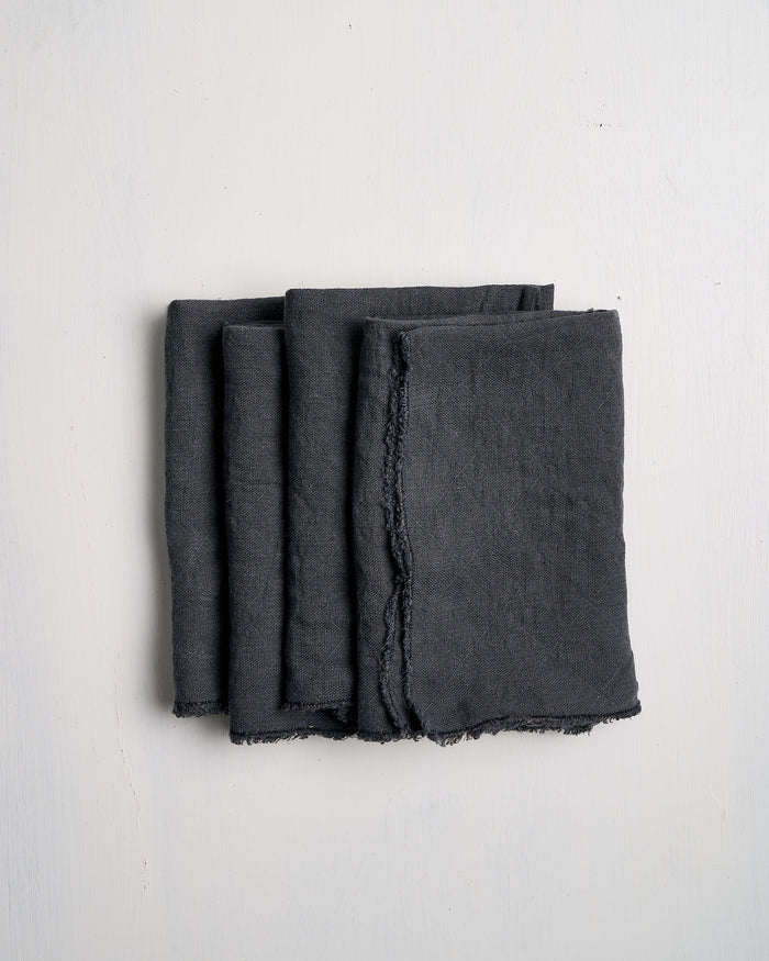 Set of three Slate Philo Linen napkins on a white background