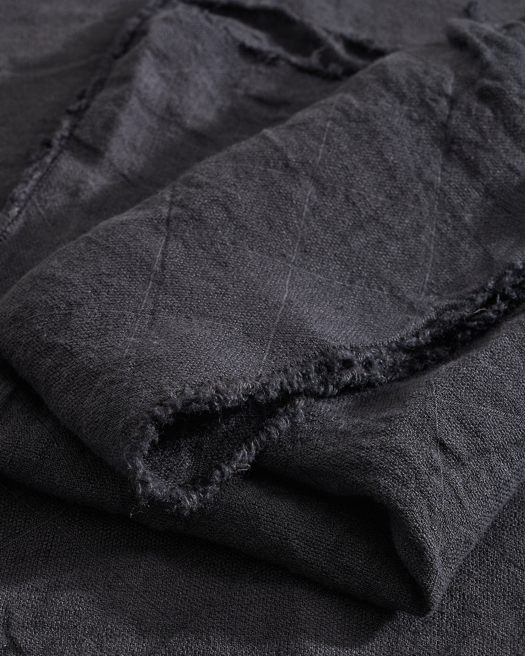 Close-up of Slate Philo Linen Napkin with a subtle pattern on a matching background