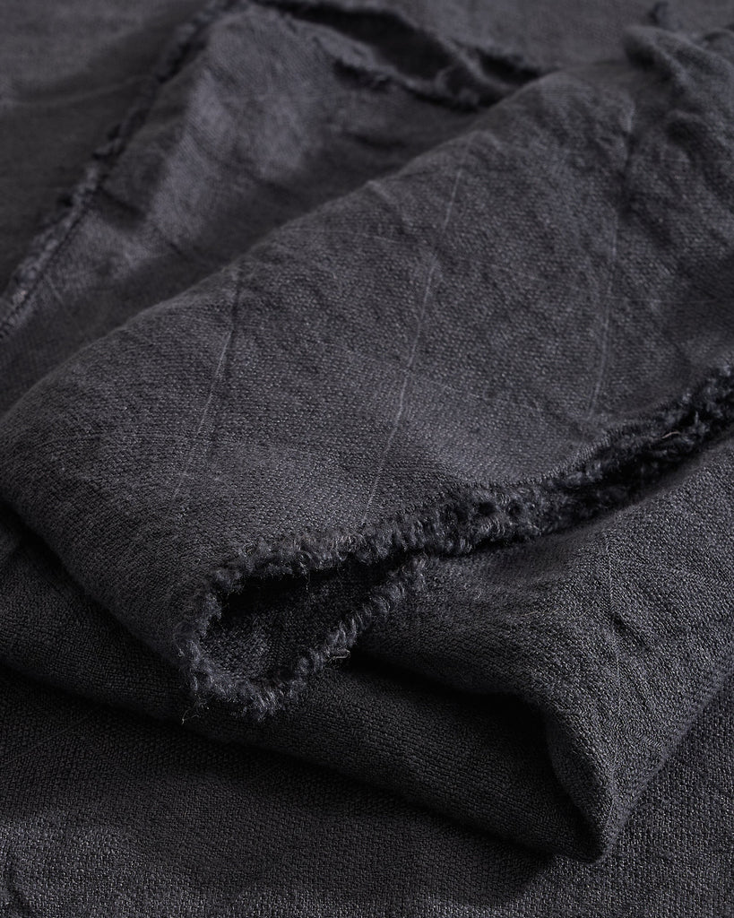 Close-up of Slate Philo Linen Napkin with a subtle pattern on a matching background