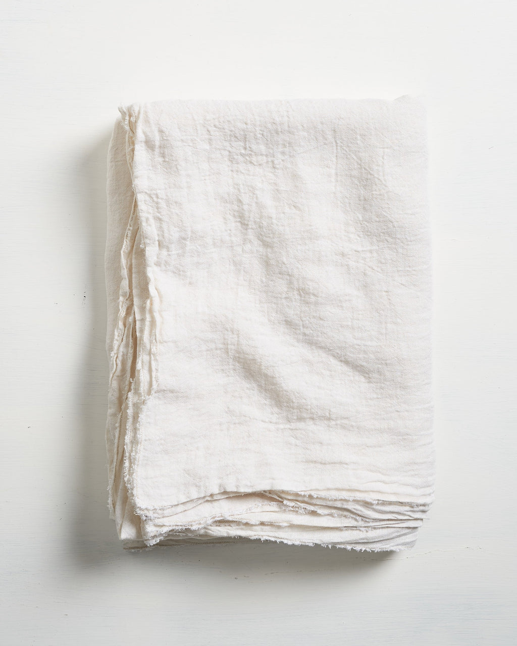 White Philo Linen tablecloth on a light gray background