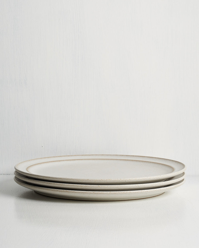 Three ceramic Pillar Dinner plates stacked on a white surface with a light gray background