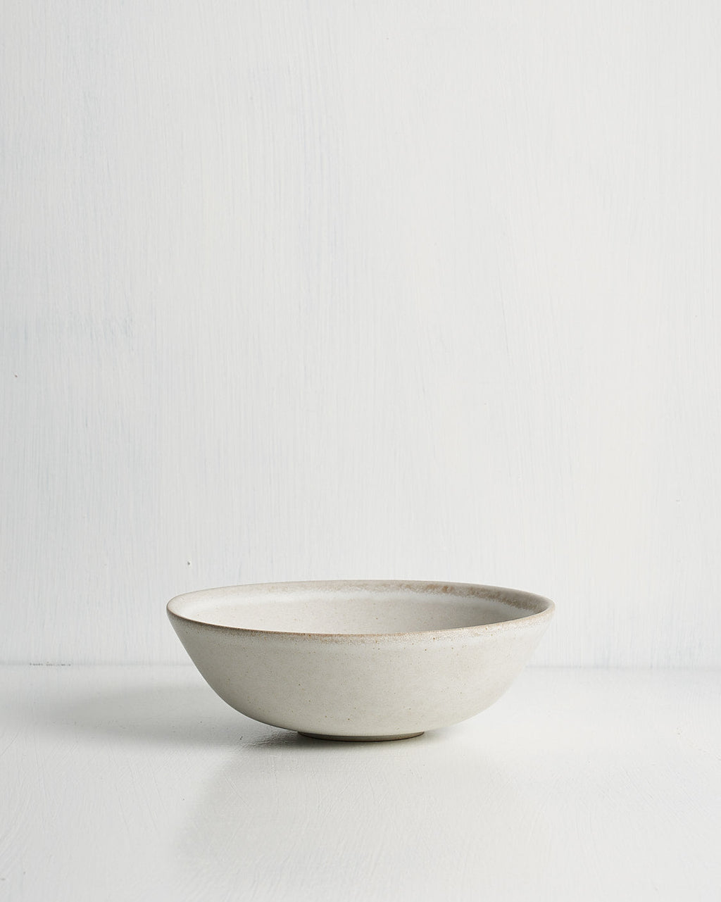 White ceramic Pillar low small bowl on a light gray background