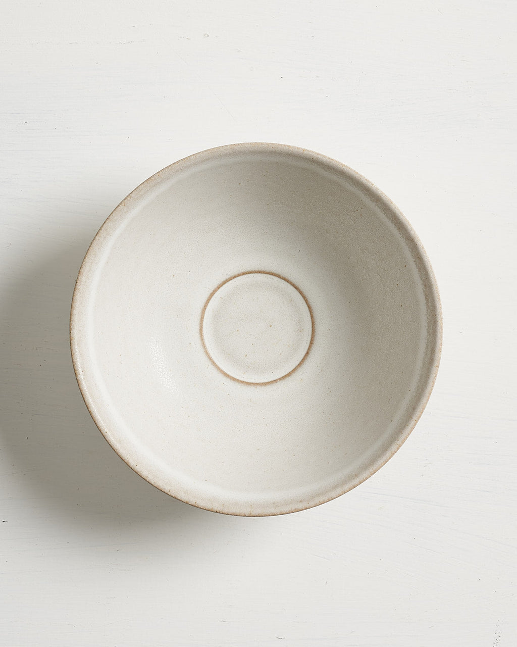 Beige ceramic Pillar low small bowl on a white background