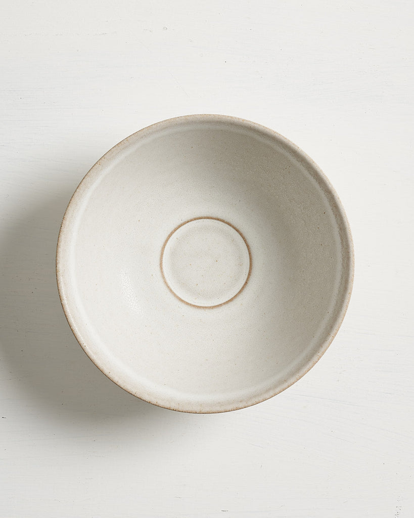 Beige ceramic Pillar low small bowl on a white background
