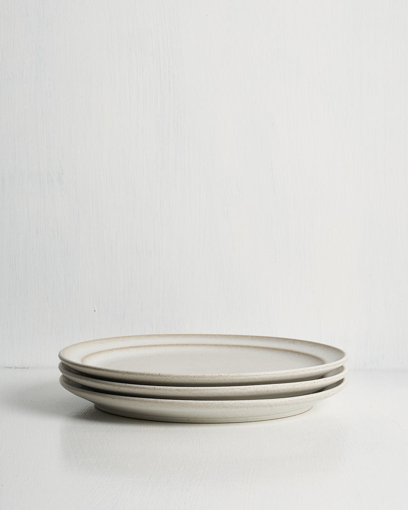 Three ceramic Pillar Salad plates stacked on a white surface with a light gray background