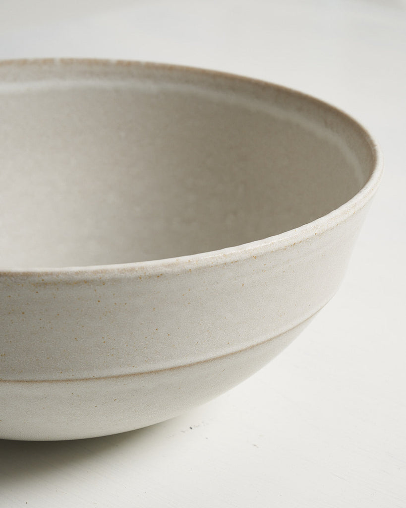 Beige ceramic Pillar Serving Bowl bowl on a light gray background