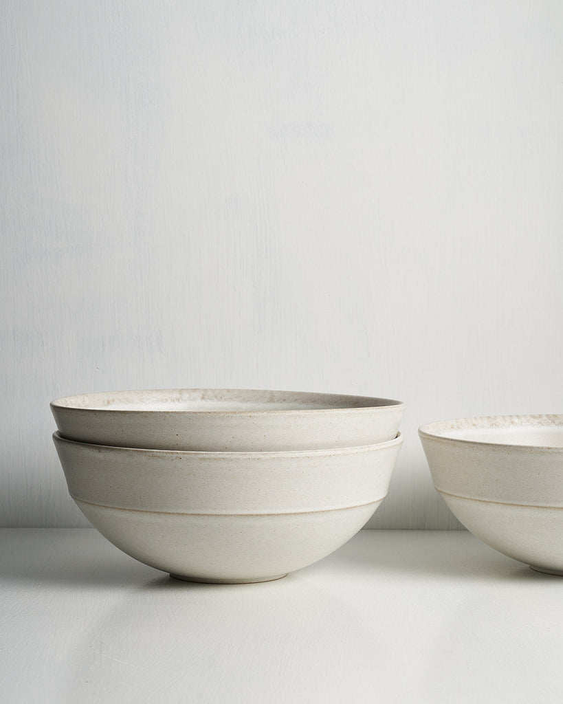 Three ceramic Pillar Serving bowls of varying sizes on a light gray background