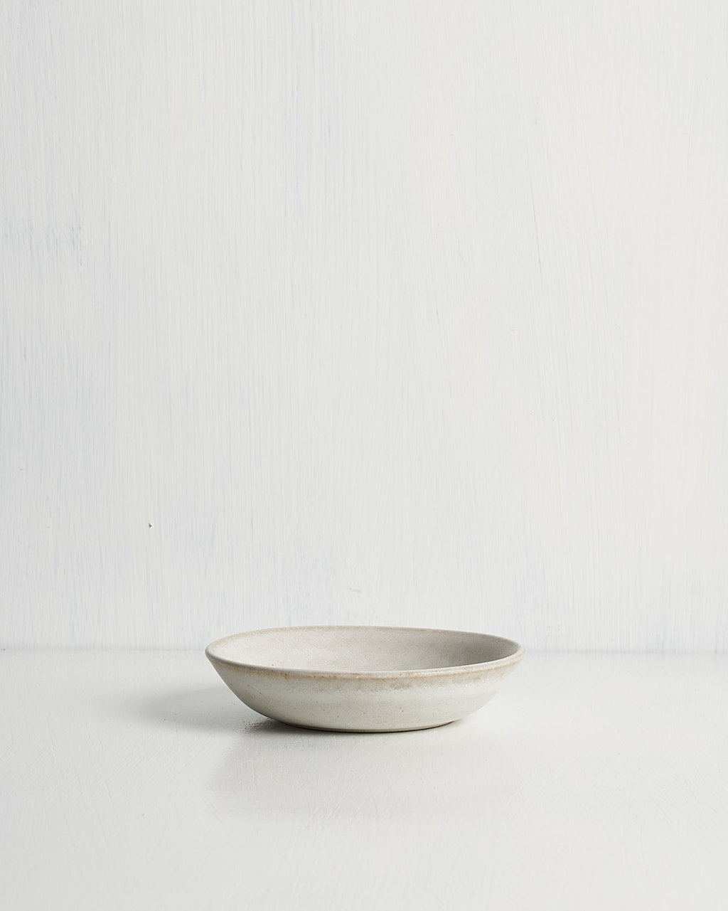 White ceramic Pillar Snack bowl on a light gray background