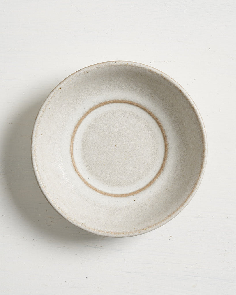 White ceramic Pillar Snack bowl with brown rim on a white background