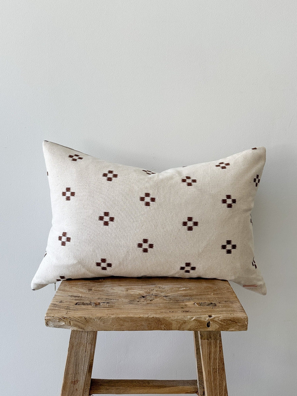 Brown checkered lumbar pillow with unique handcrafted textile and linen backing, 20x20 inches.