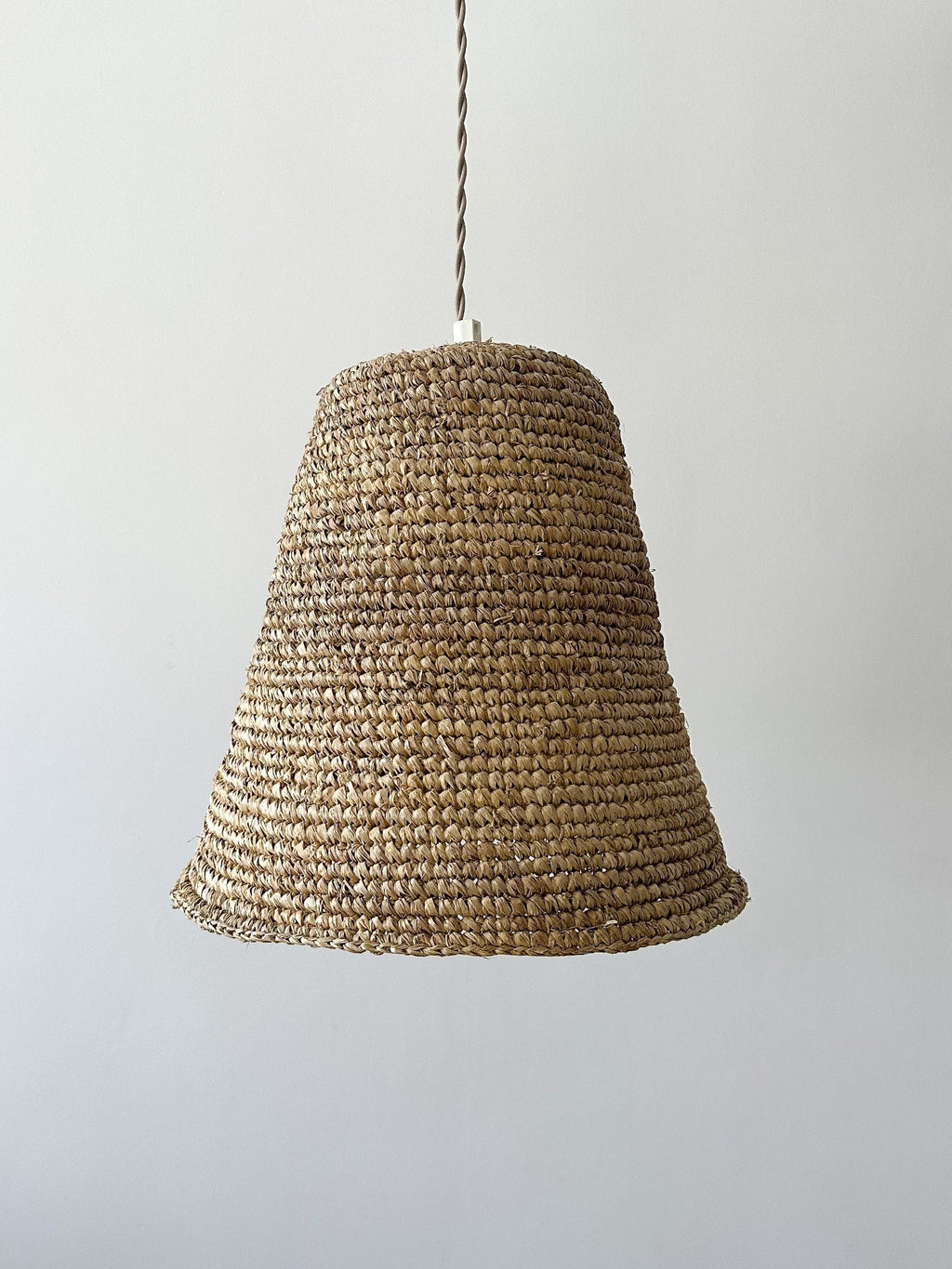 Handwoven Bali Bell Pendant light made from water hyacinth with antique brass fittings