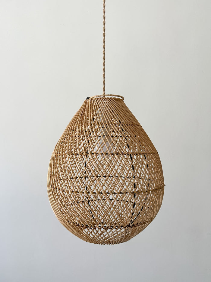 Front product view of the Teardrop Basket Pendant hanging in front of a cream wall. - Saffron and Poe.