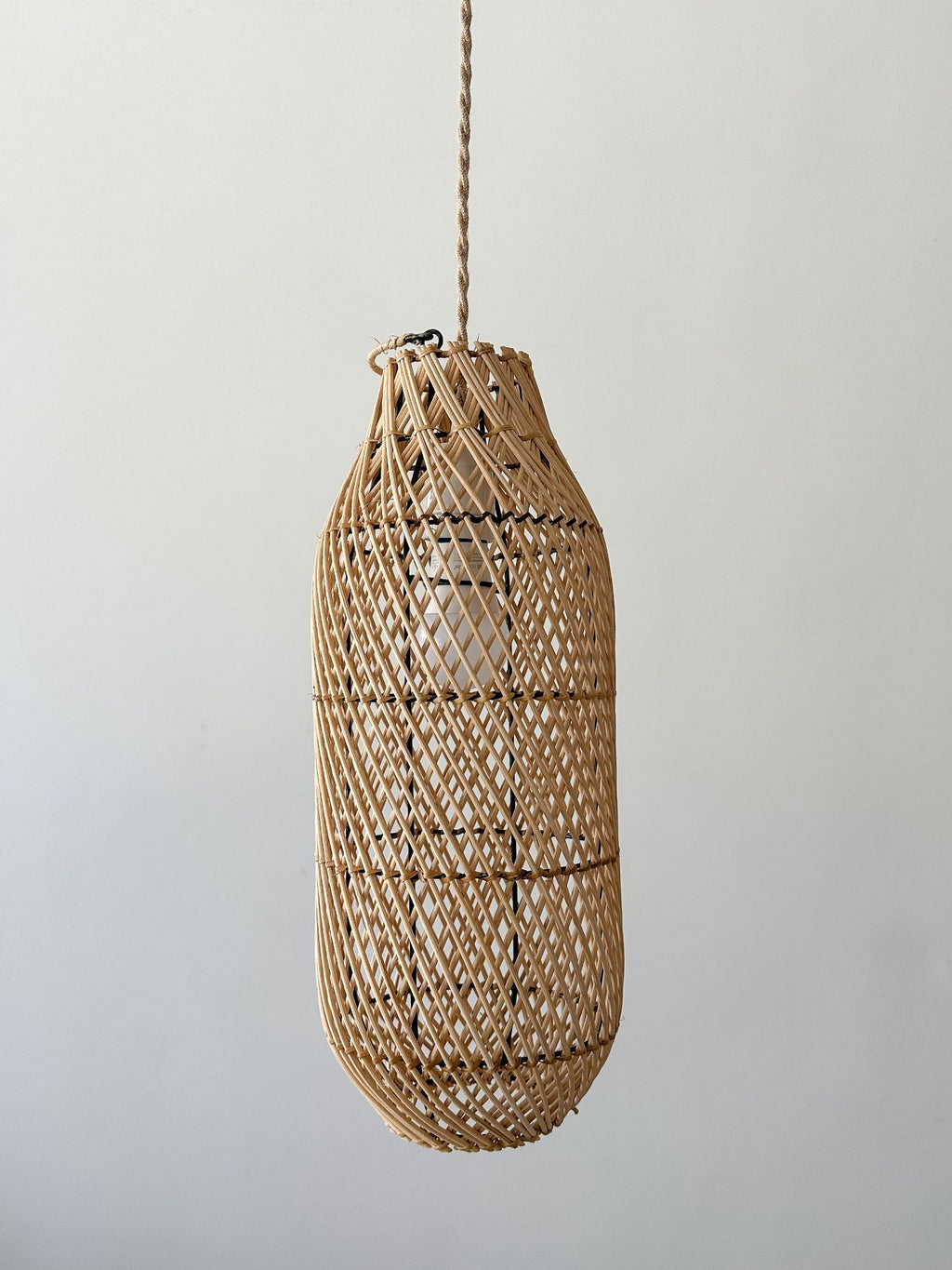 Handwoven oblong basket pendant light with rattan design and twisted jute cord