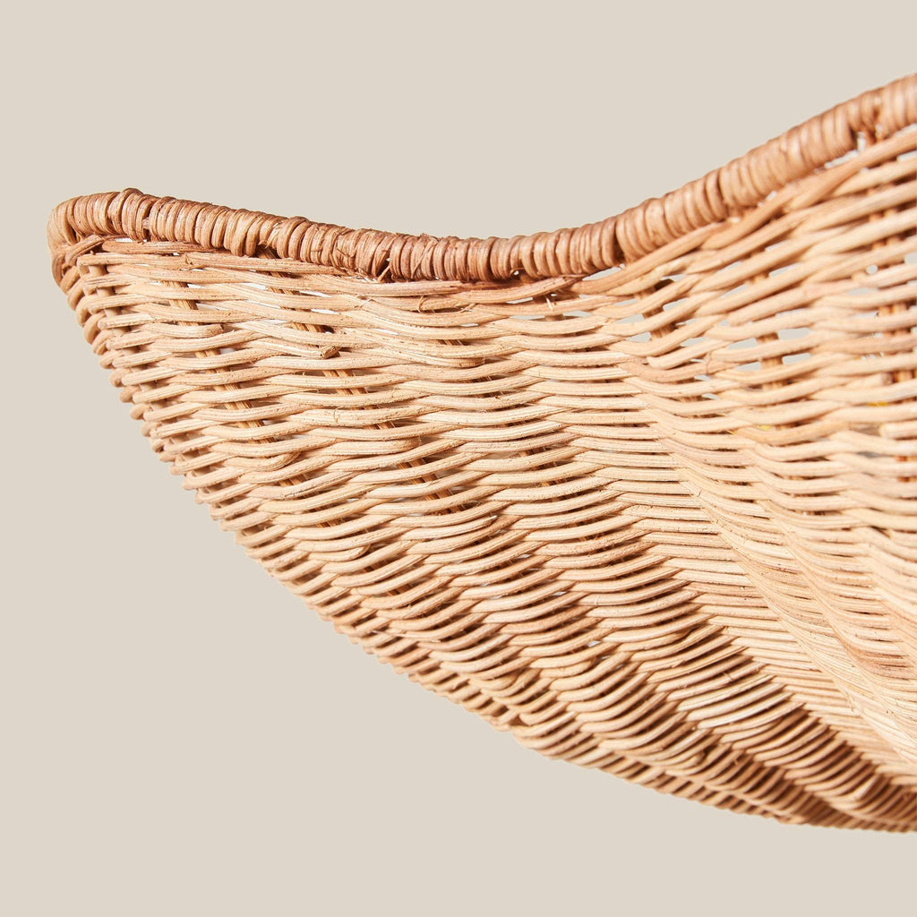 Close-up of a Ravello Flushmount wicker shade corner on a neutral background