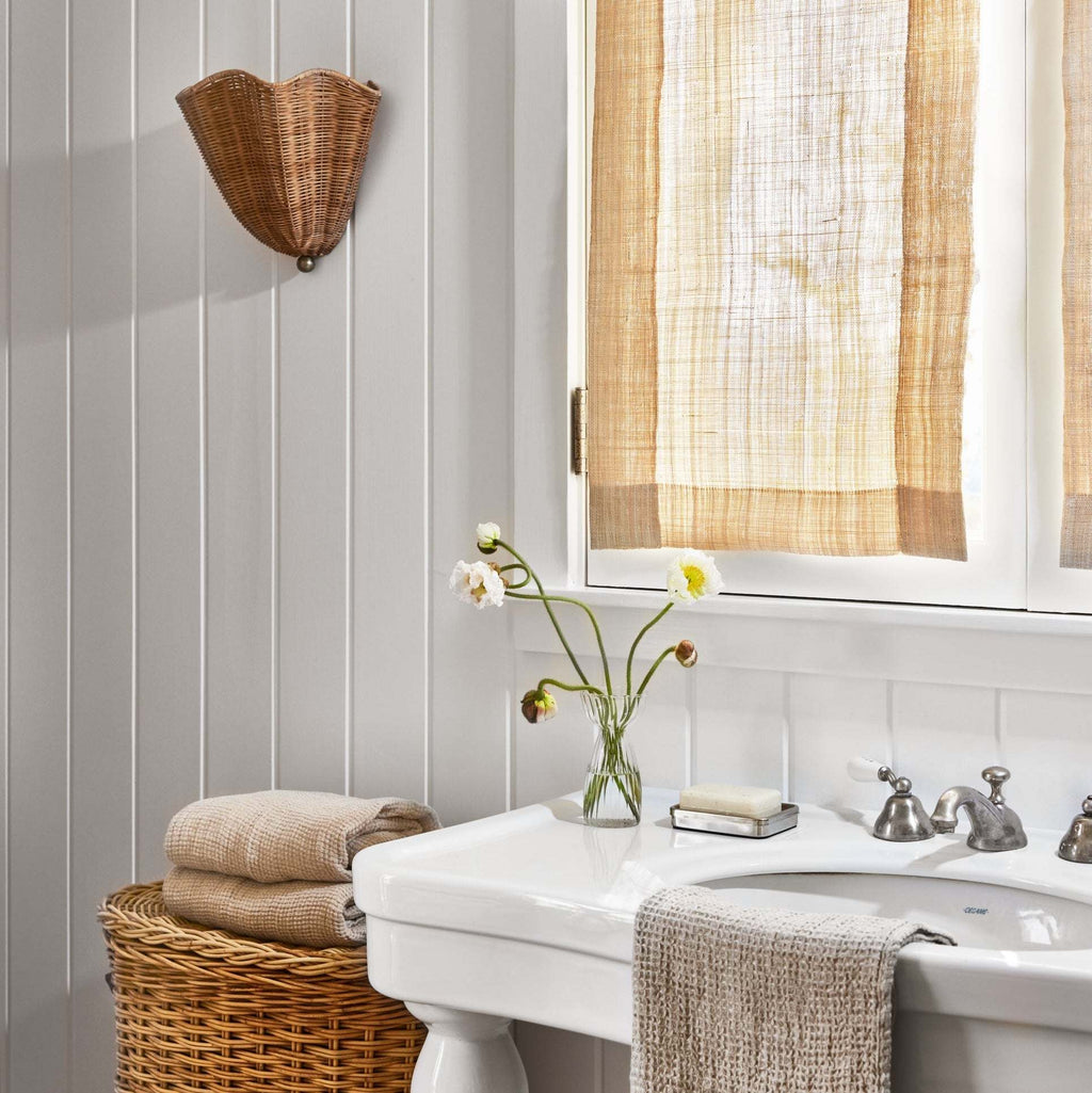 Bathroom with a sink, flowers, and a Ravello Wall Sconce