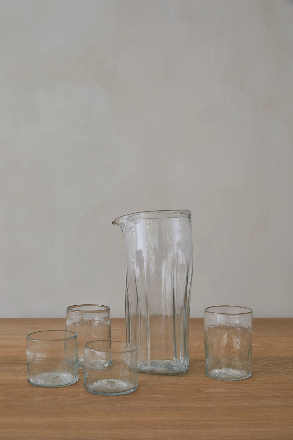 Handblown glass pitcher made from recycled glass with unique texture and classic shape