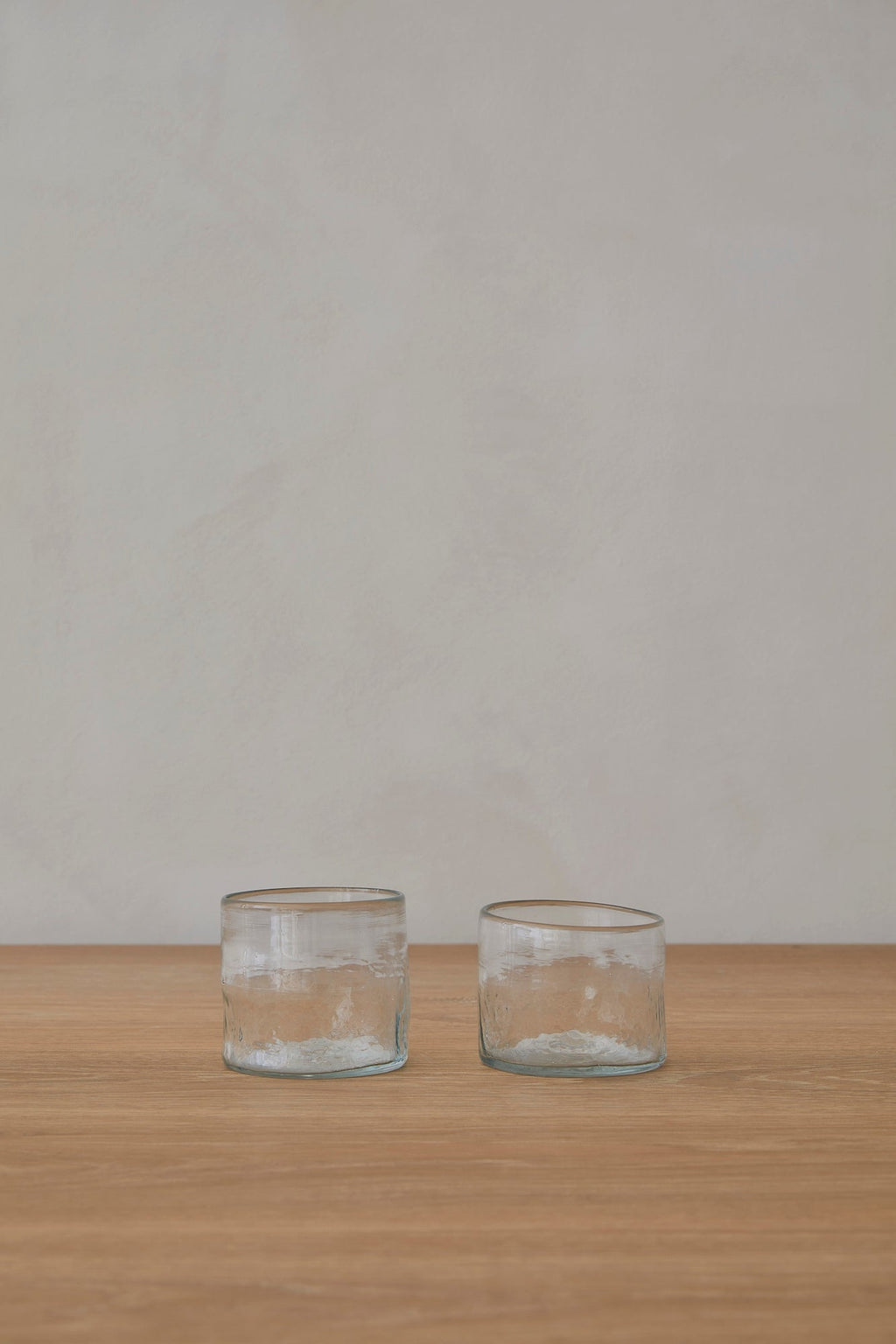 Set of 2 small handblown glass tumblers from recycled glass with organic texture and round shape