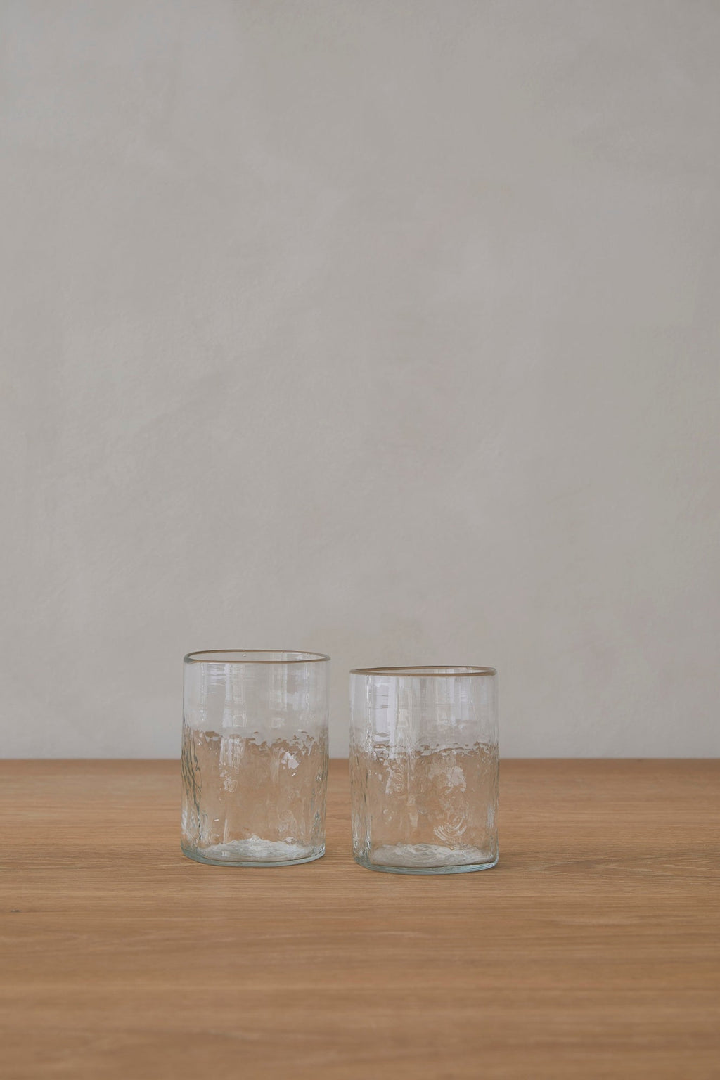 Set of two medium handblown glass tumblers made from recycled glass with unique texture and organic shape